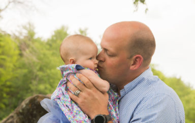 Father kissing baby in his arms