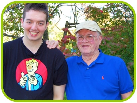 Man with hand on young man's shoulder