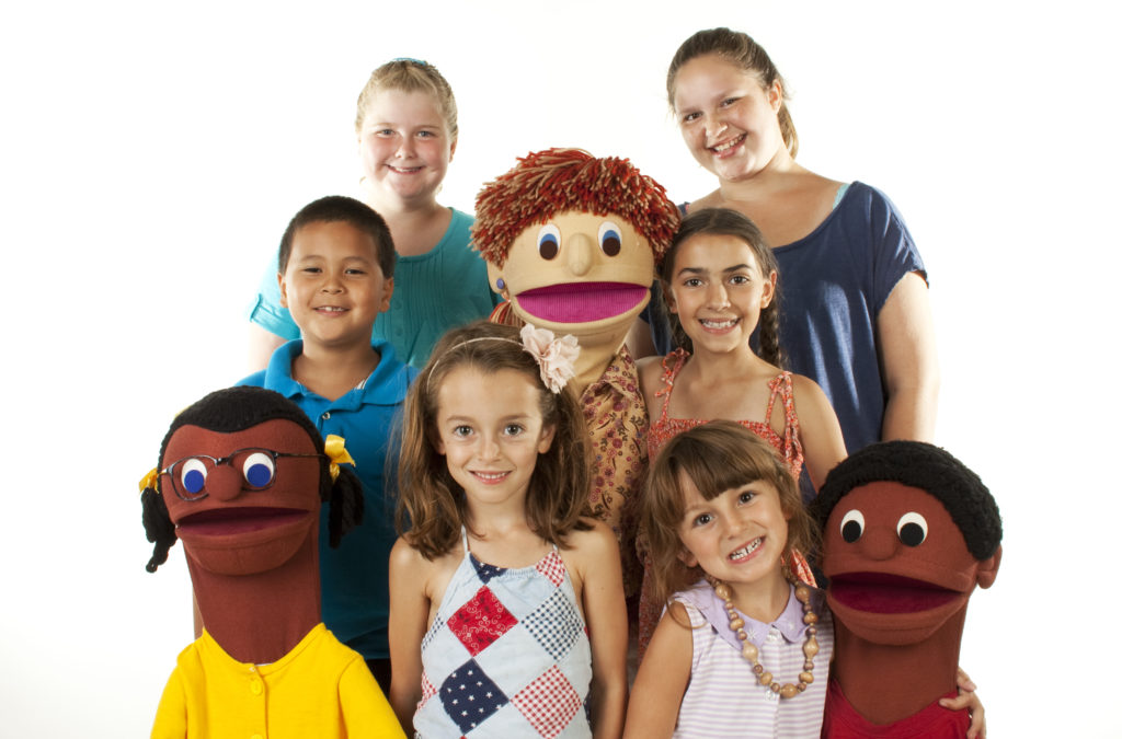 Six children of different ages and genders with three puppets on white background