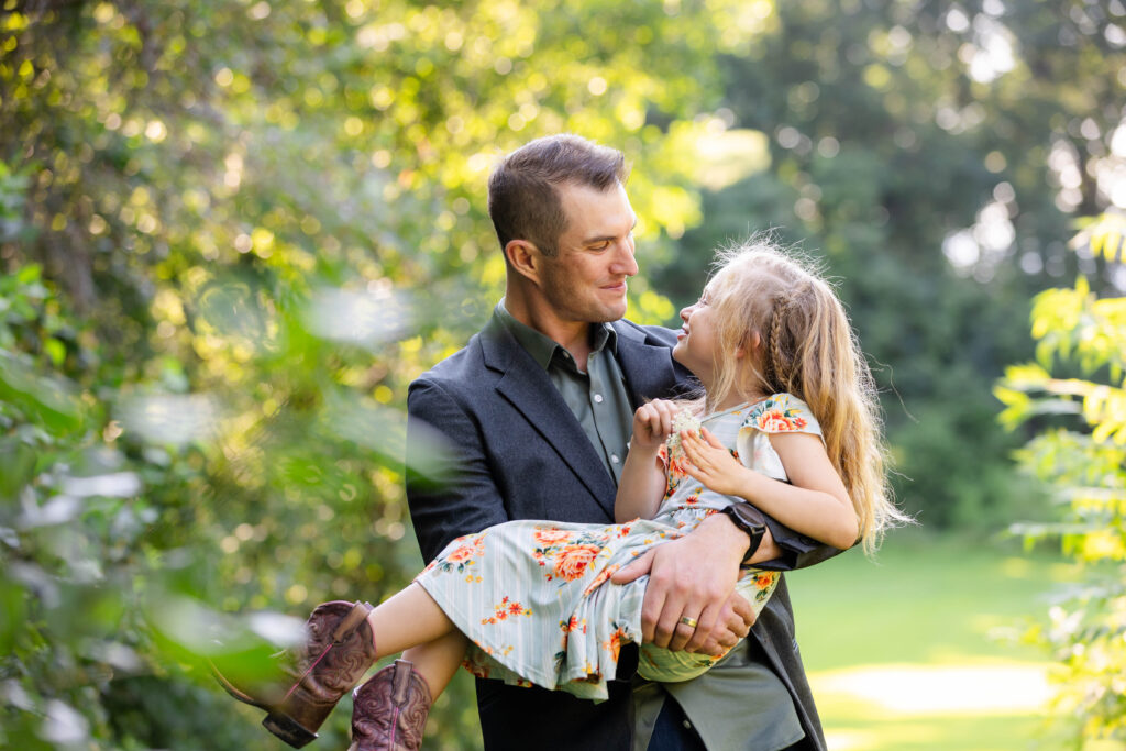 A father holding his daughter.